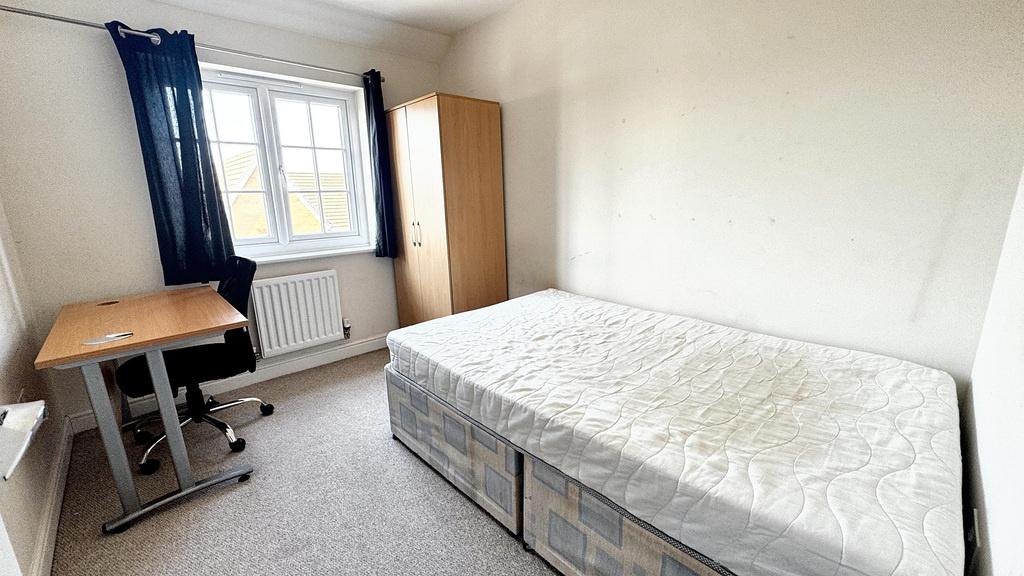 A modest single bedroom featuring a single bed,...