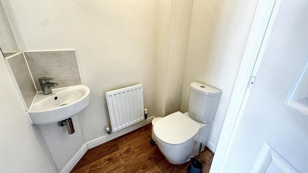 A clean and bright bathroom featuring a toilet,...