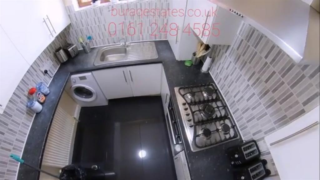 Photo of a compact kitchen area featuring a cou...