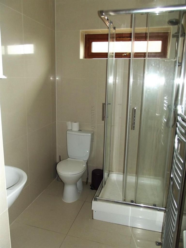 A clean and modern bathroom featuring a shower ...