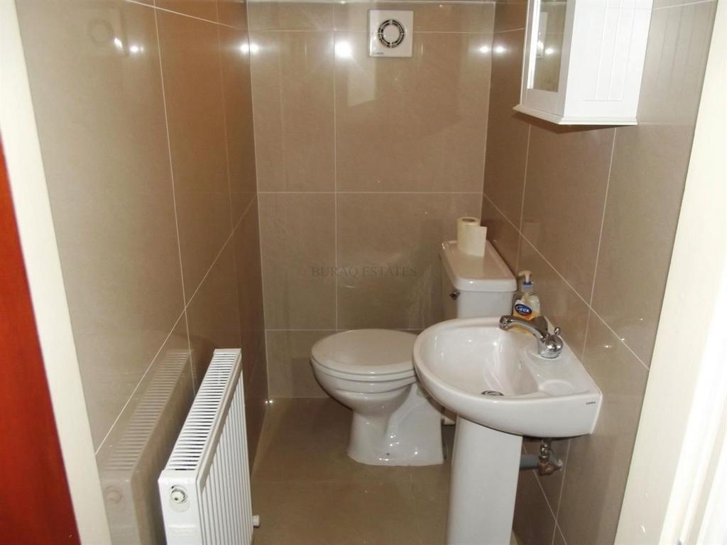 A clean and functional bathroom with a toilet, ...