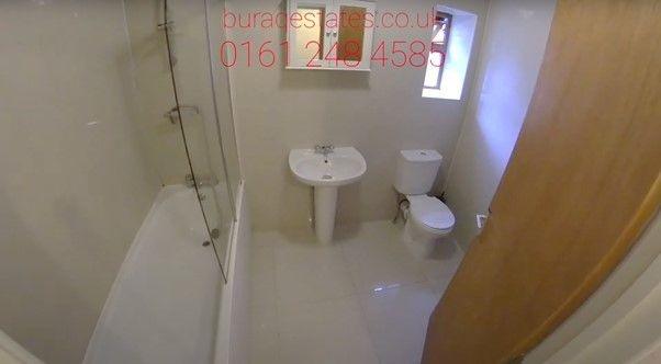 A spacious bathroom featuring a large bathtub a...