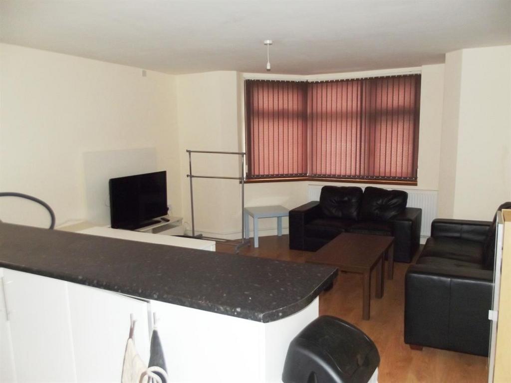 A spacious and well-lit contemporary living roo...