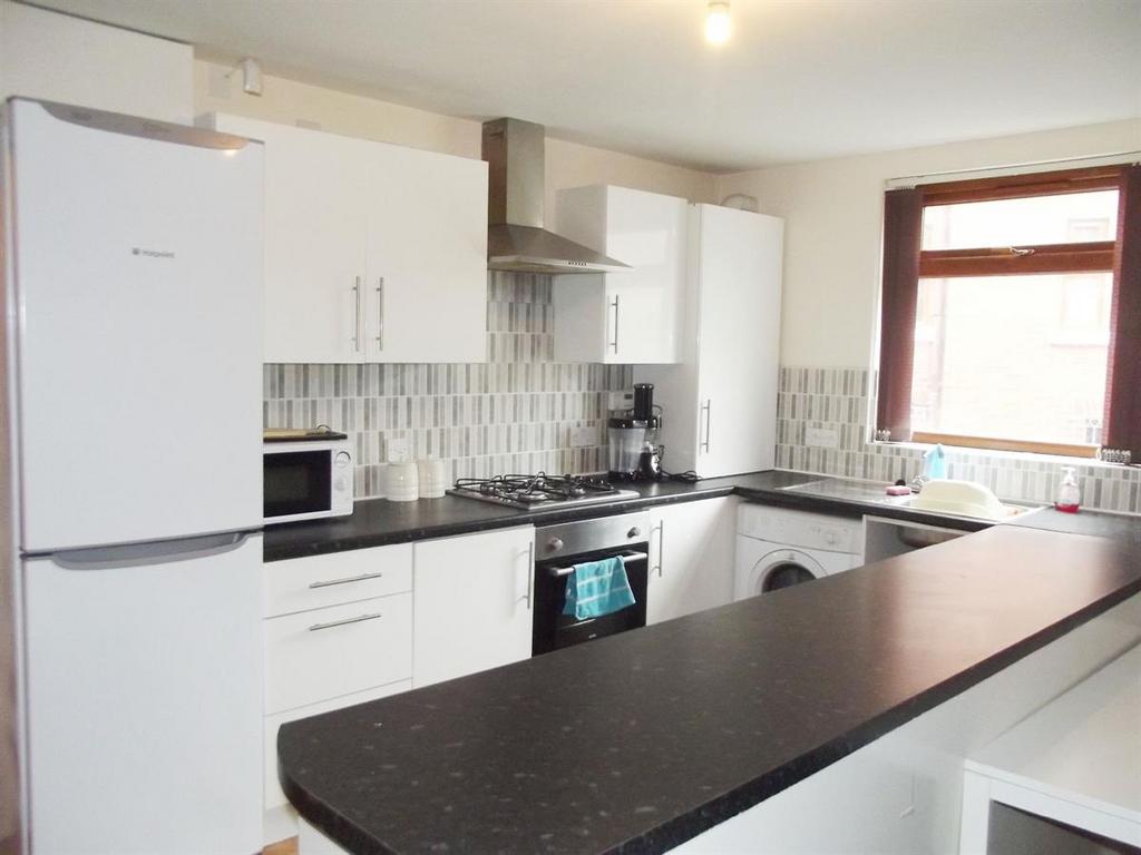 A bright and modern kitchen with ample natural ...