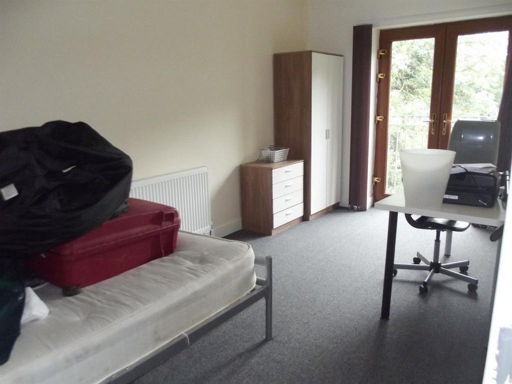 A spacious bedroom featuring a single bed frame...