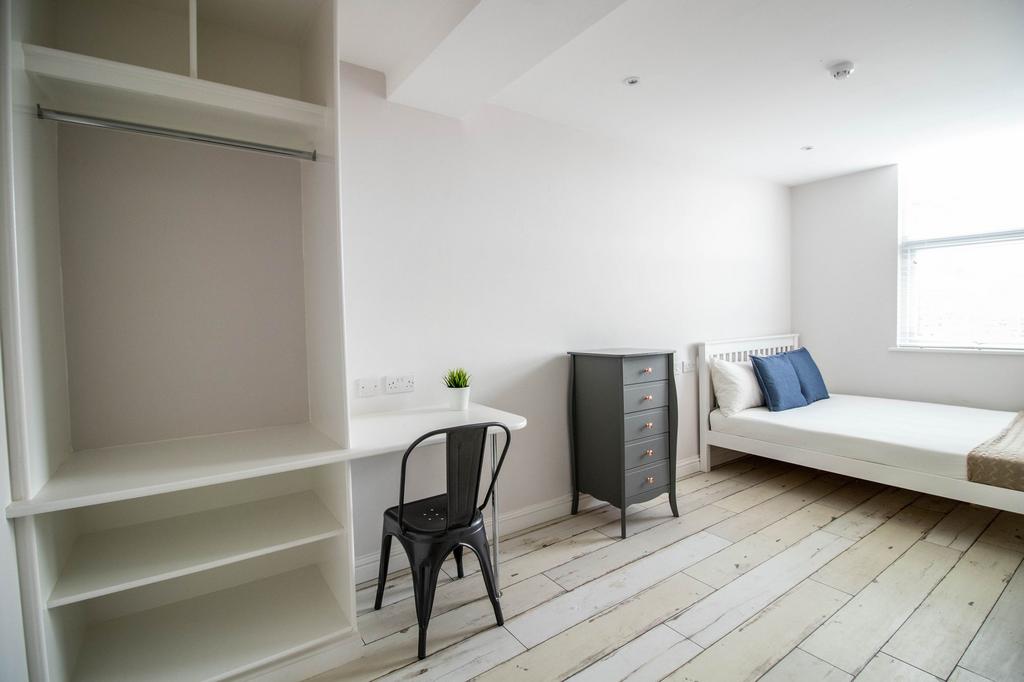 Bright and airy master bedroom featuring a comf...
