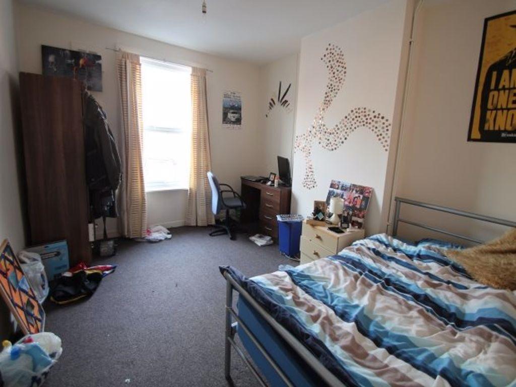 A cozy bedroom with a neatly made bed, providin...