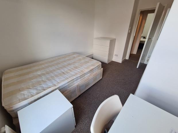 A simple, tidy single bedroom with a single bed...