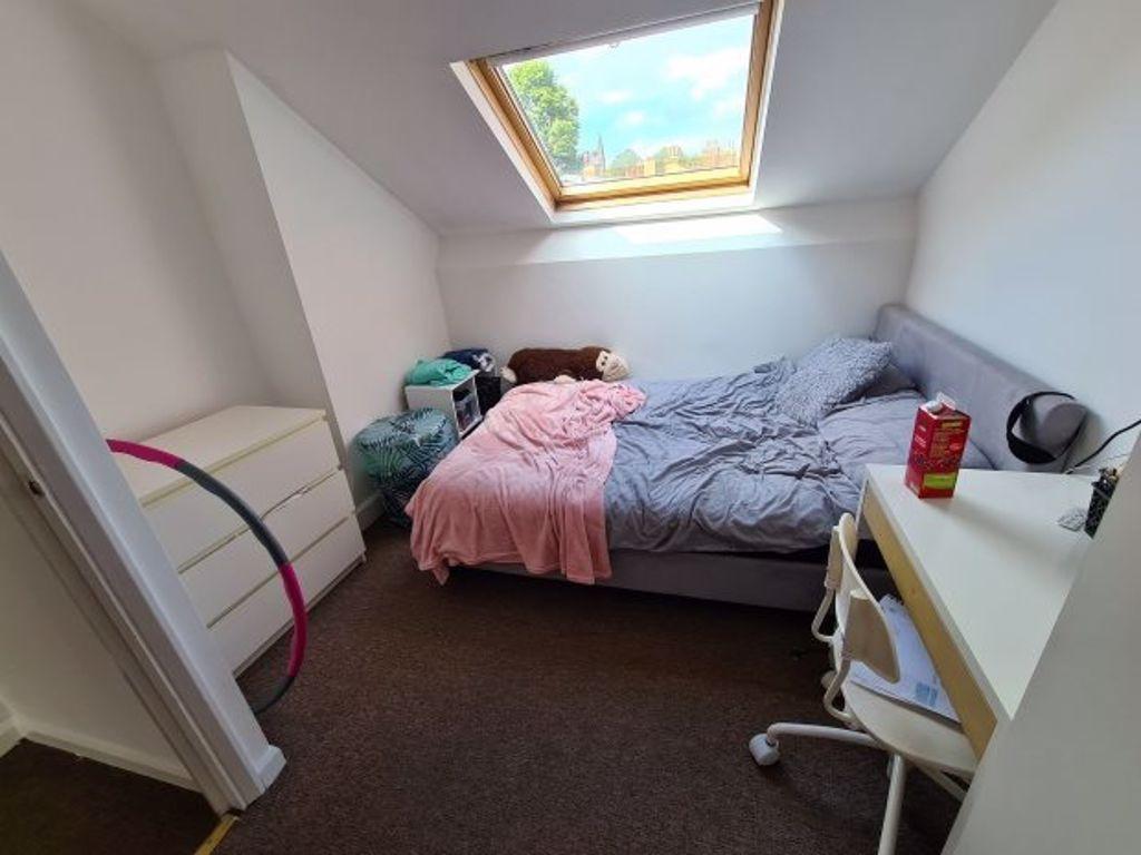 A bright and cozy master bedroom with a large w...