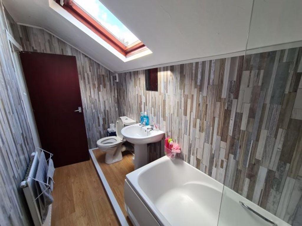 A well-maintained bathroom featuring a bathtub,...