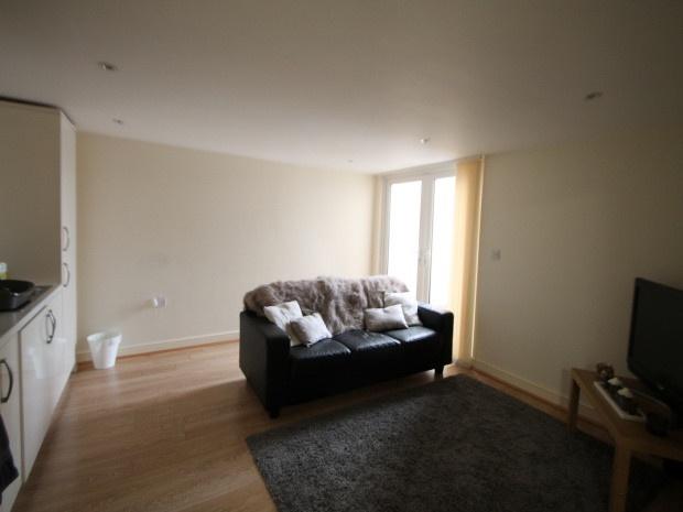A bright and spacious living room featuring a c...