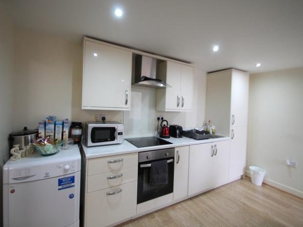 A well-maintained modern kitchen with ample nat...
