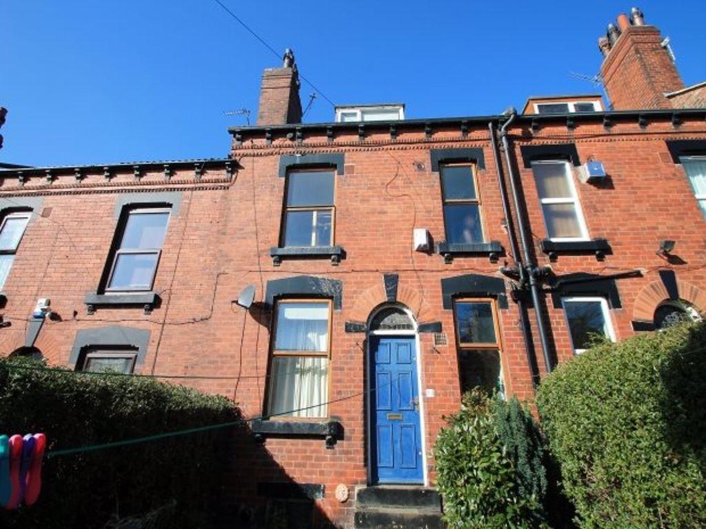 A charming red brick house with a striking blue...