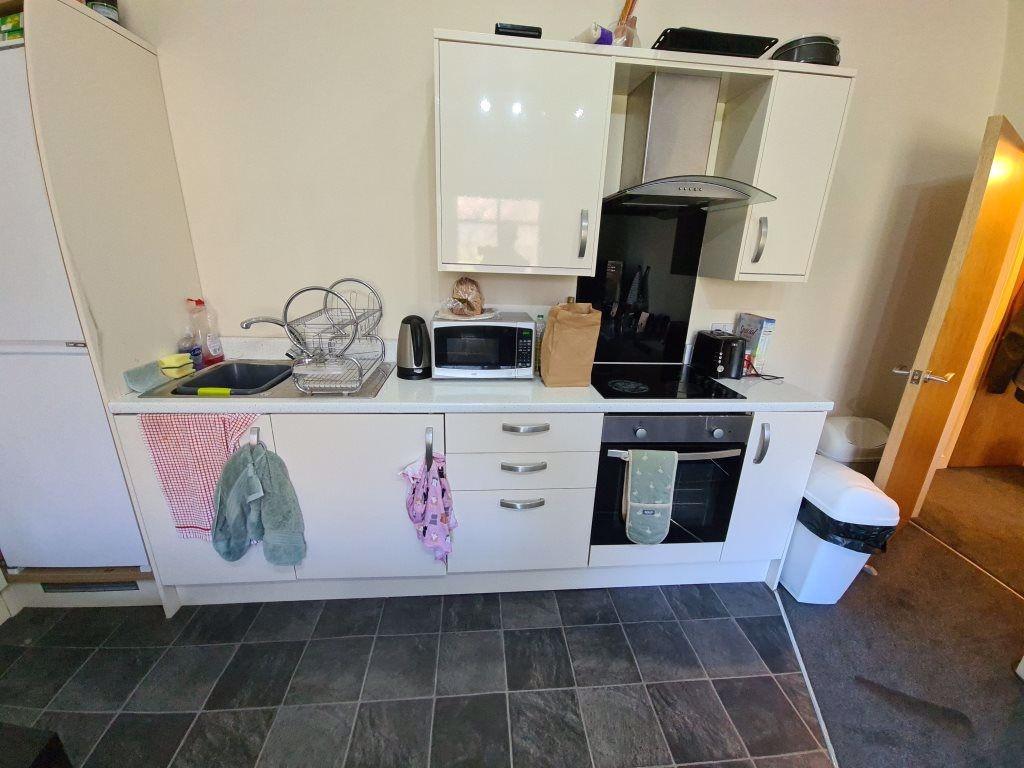 Modern kitchen with clean surfaces, equipped wi...