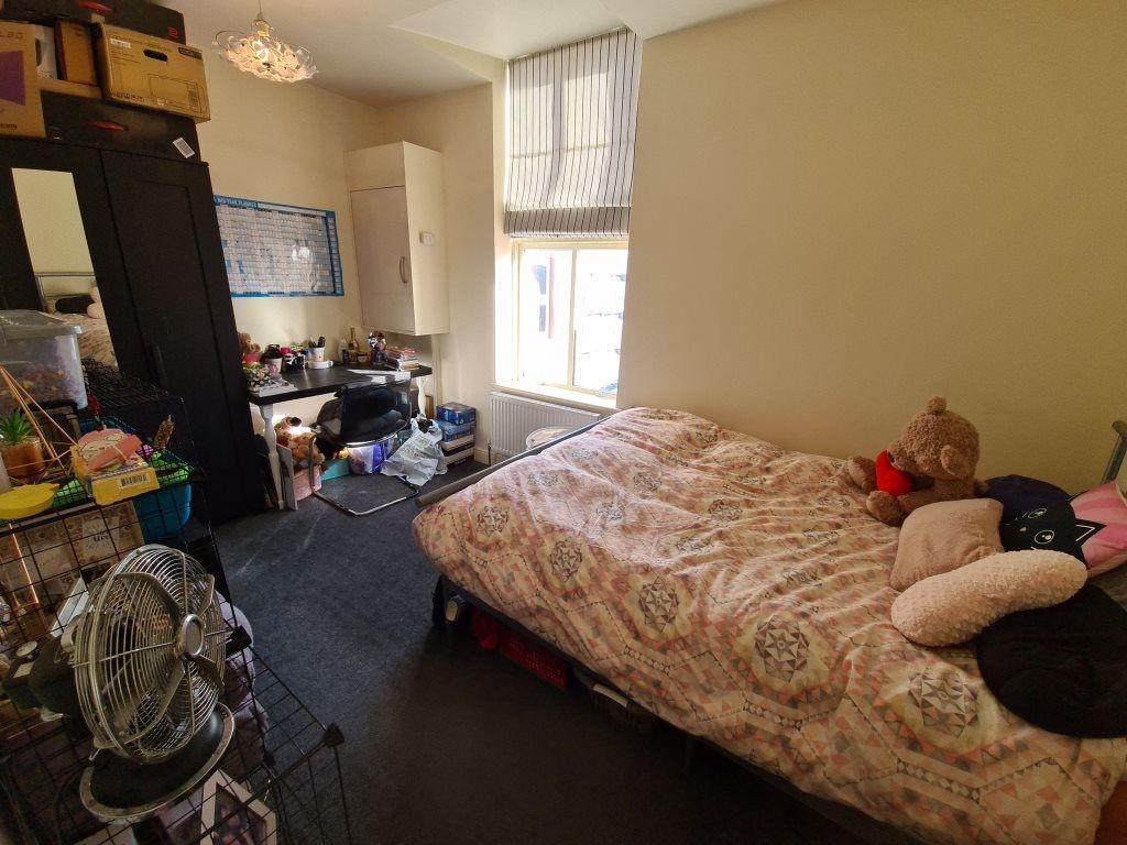 A cozy bedroom featuring a double bed with soft...