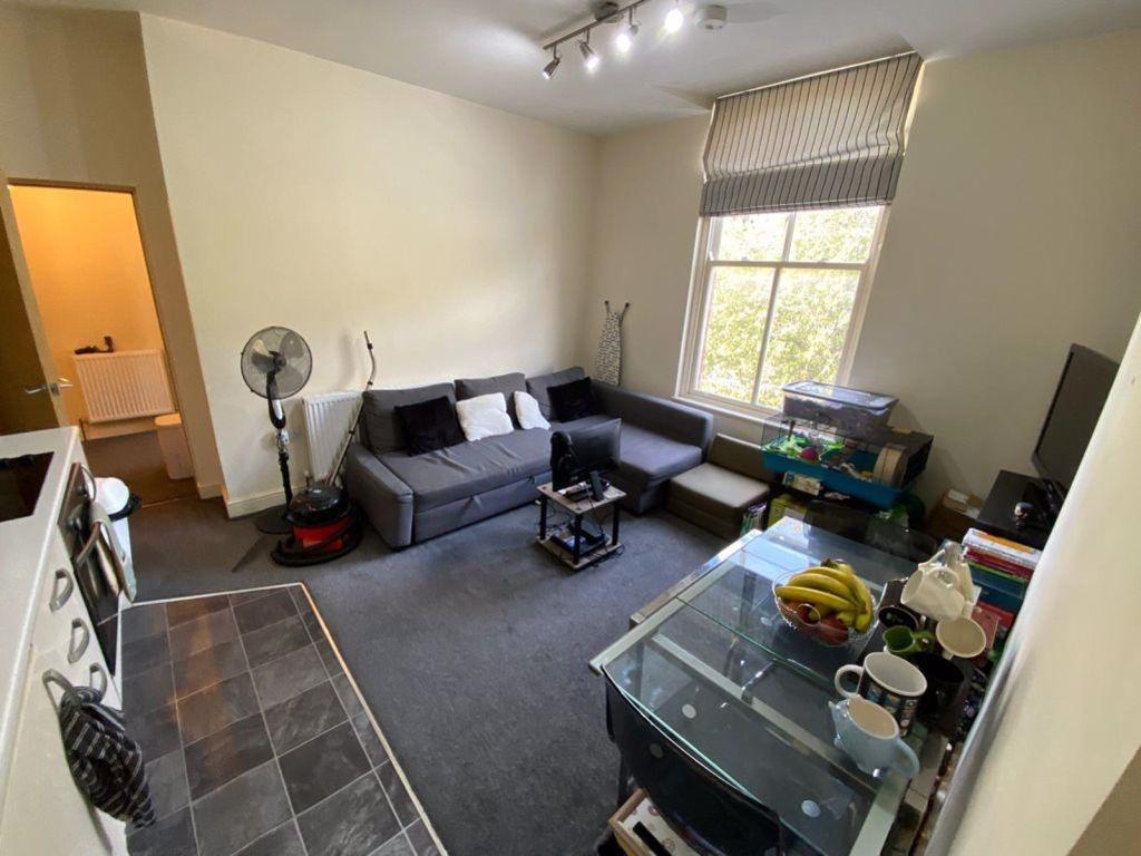 A spacious and welcoming living room with large...