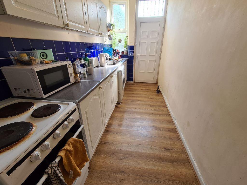 A compact kitchen with basic appliances and a m...