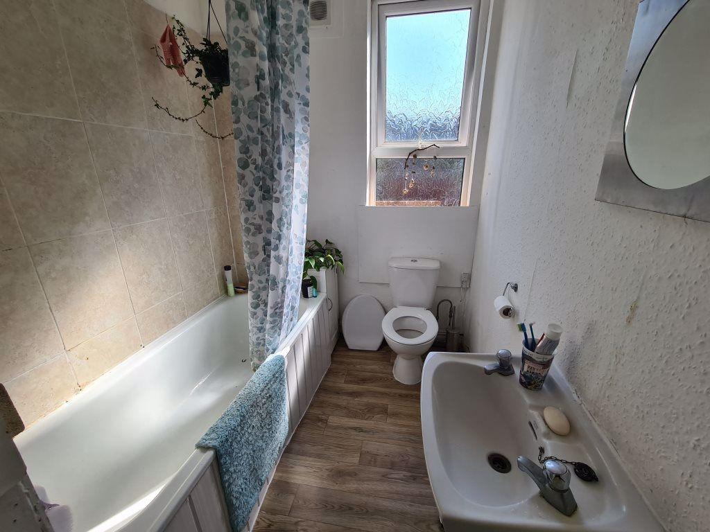 A well-maintained bathroom featuring a bathtub,...