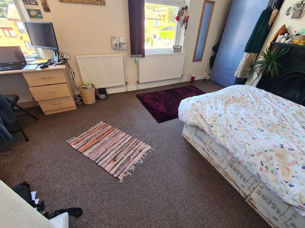 A bright, cozy bedroom featuring a double bed a...