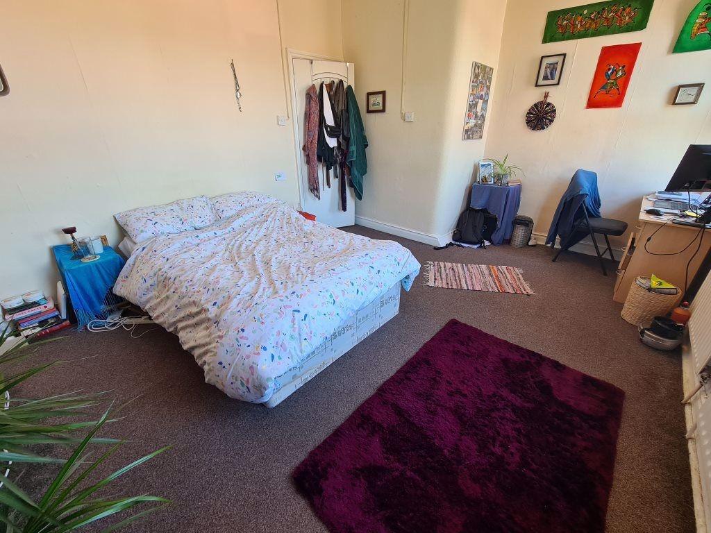 A spacious and bright double bedroom featuring ...