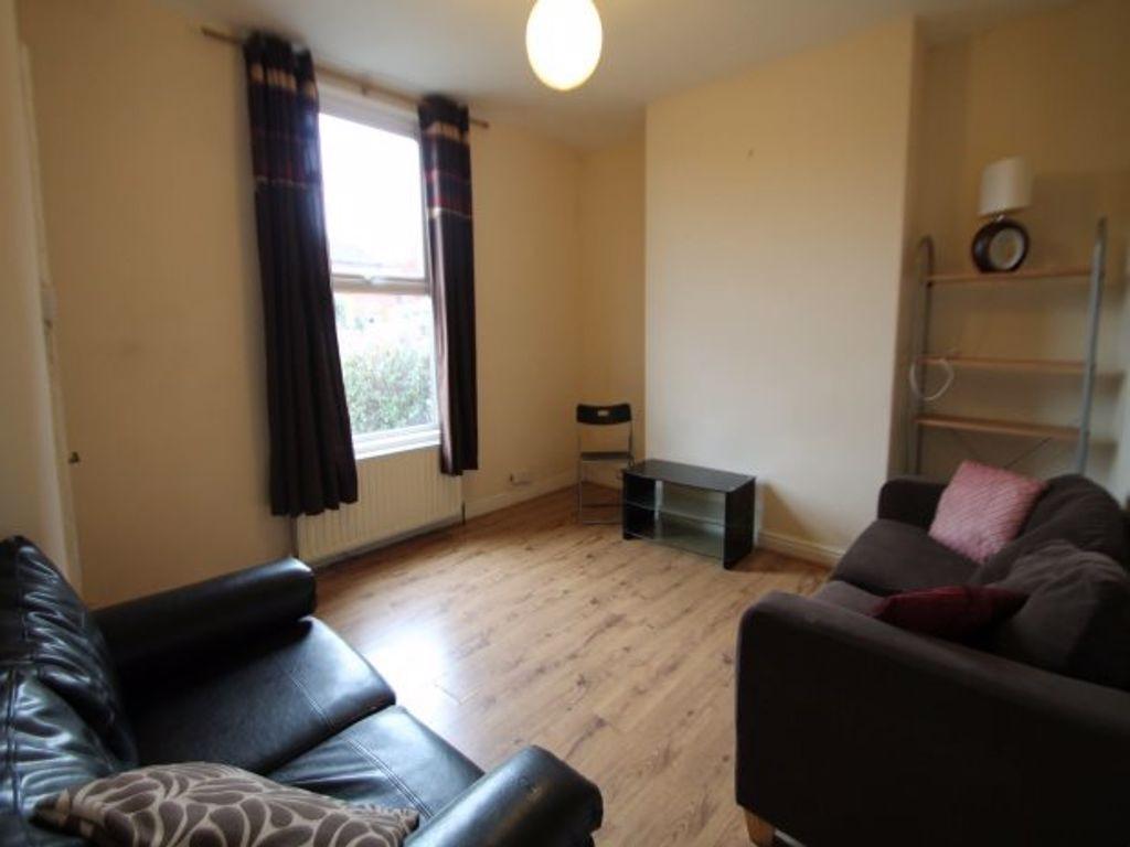 A cozy living room with two sofas, a window all...