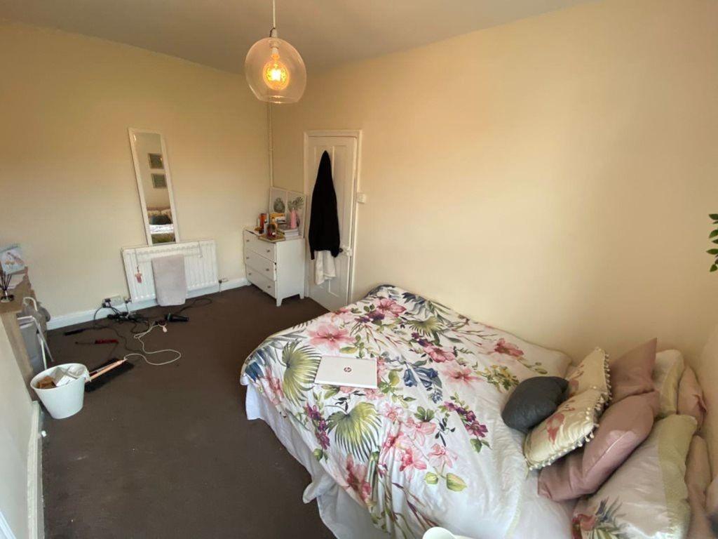 A well-lit, cozy bedroom featuring a double bed...