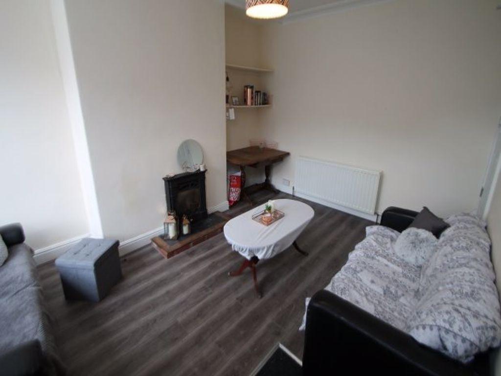 A cozy and well-maintained living room featurin...