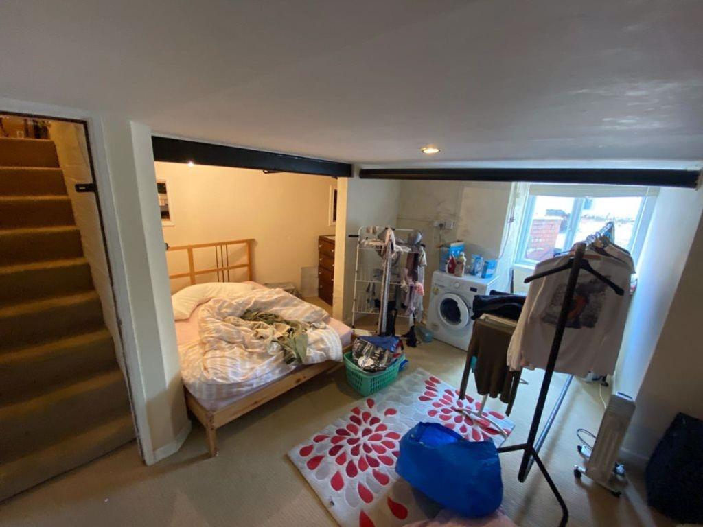 Cozy bedroom with a double bed and natural ligh...