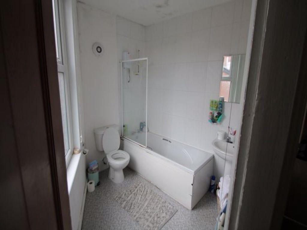 A modern bathroom featuring a bathtub, toilet, ...
