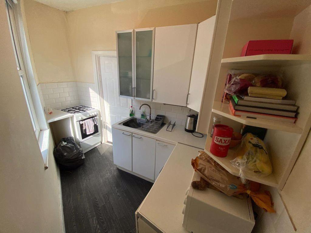 A compact but well-organized student kitchen wi...