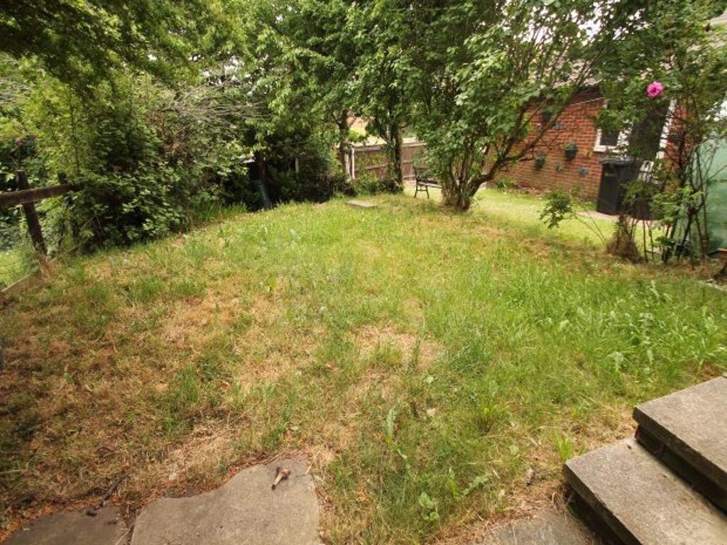 A well-maintained garden area with lush greener...
