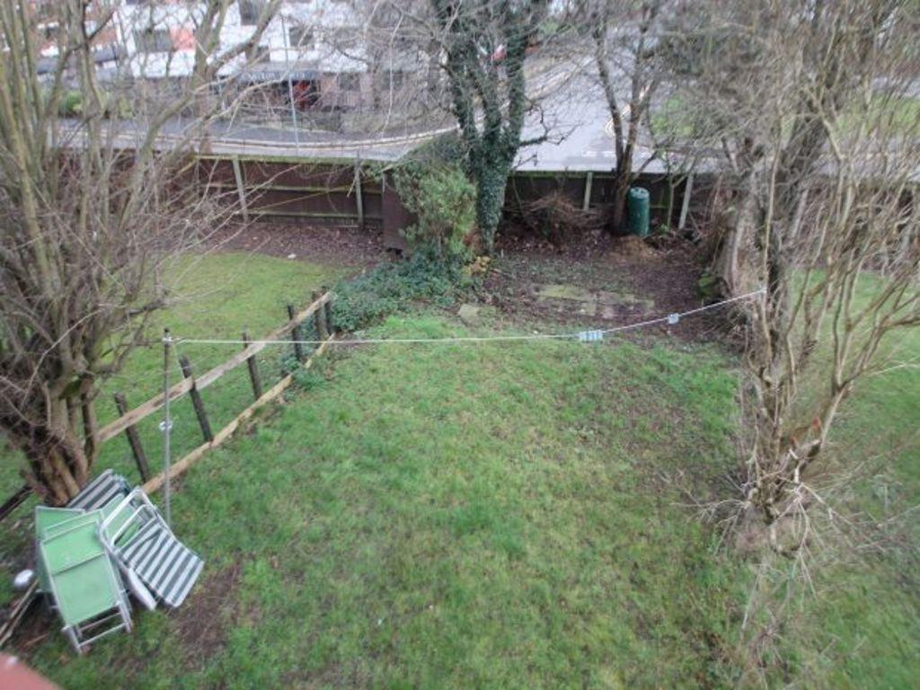 A well-maintained garden with lush grass, surro...
