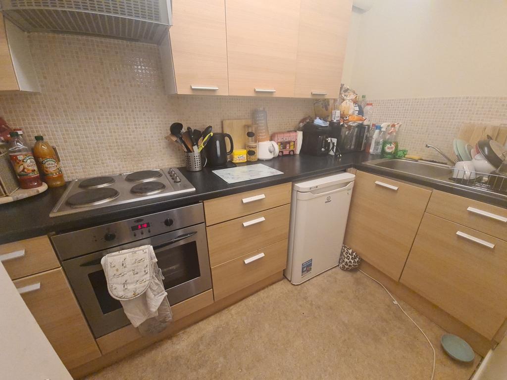 A well-maintained kitchen featuring modern cabi...