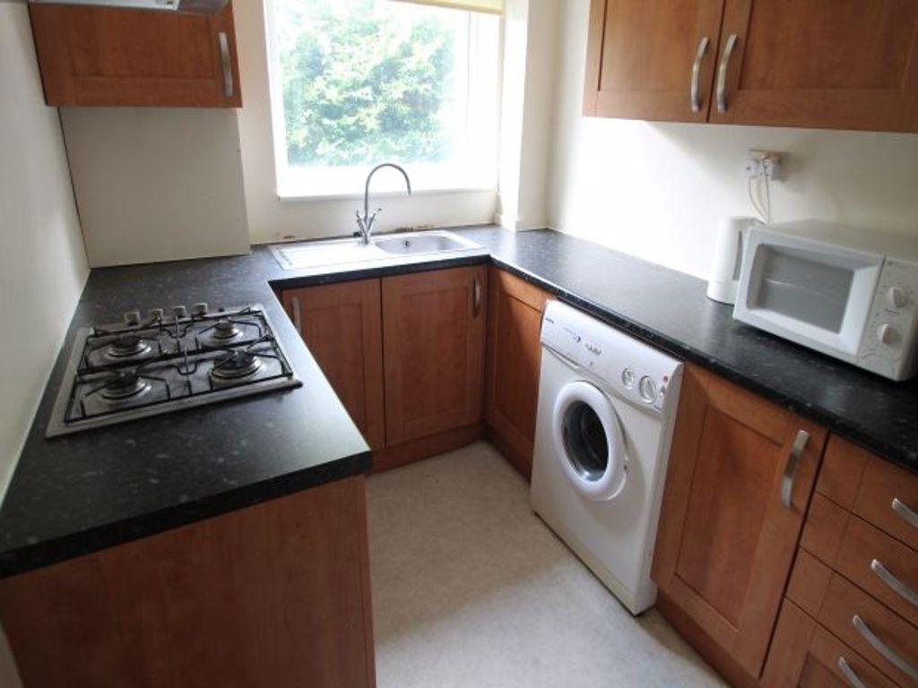 A well-maintained kitchen with wooden cabinets,...
