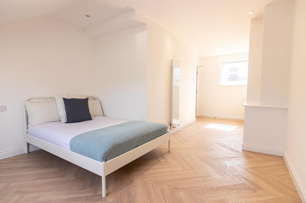 Bright and spacious master bedroom featuring a ...