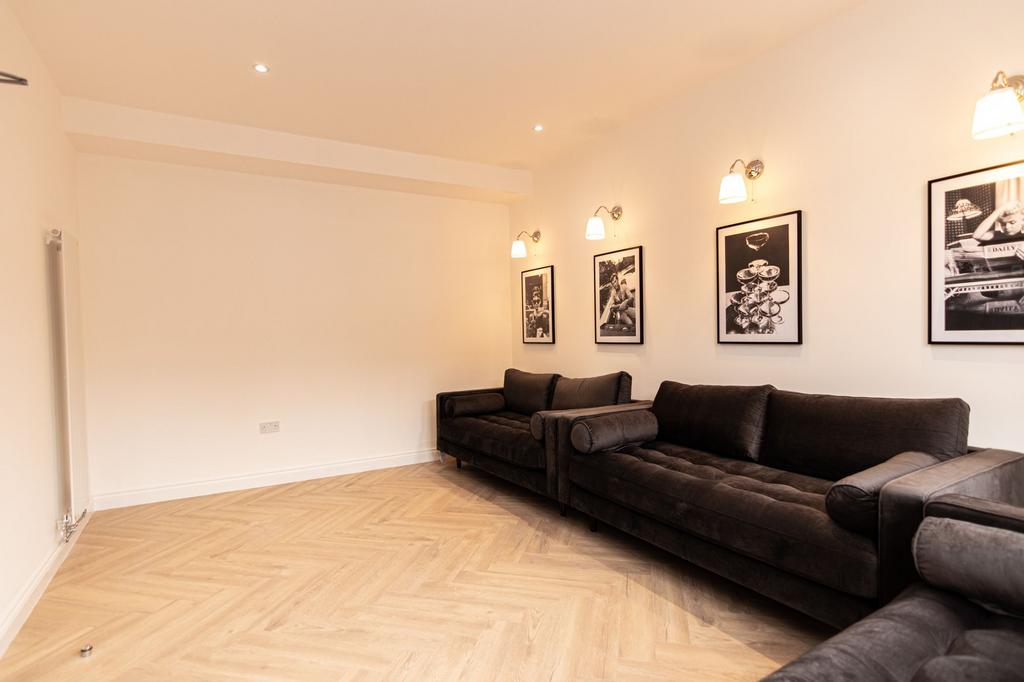 A spacious, modern living room with large sofas...