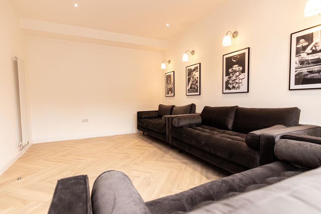 Spacious and modern living room featuring comfo...