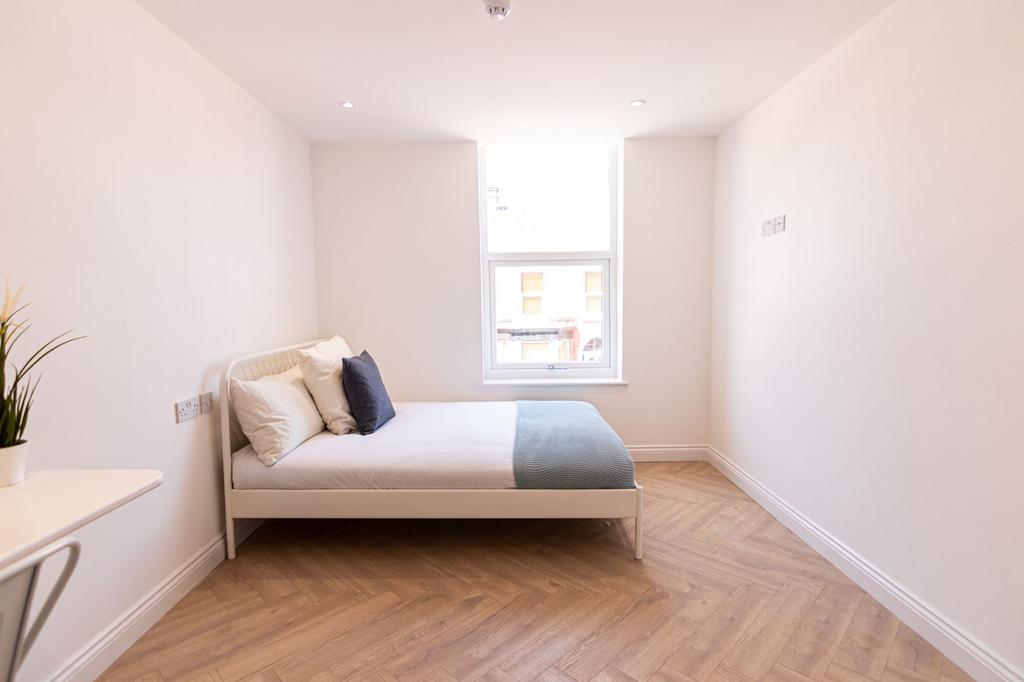Bright and inviting bedroom with a large window...