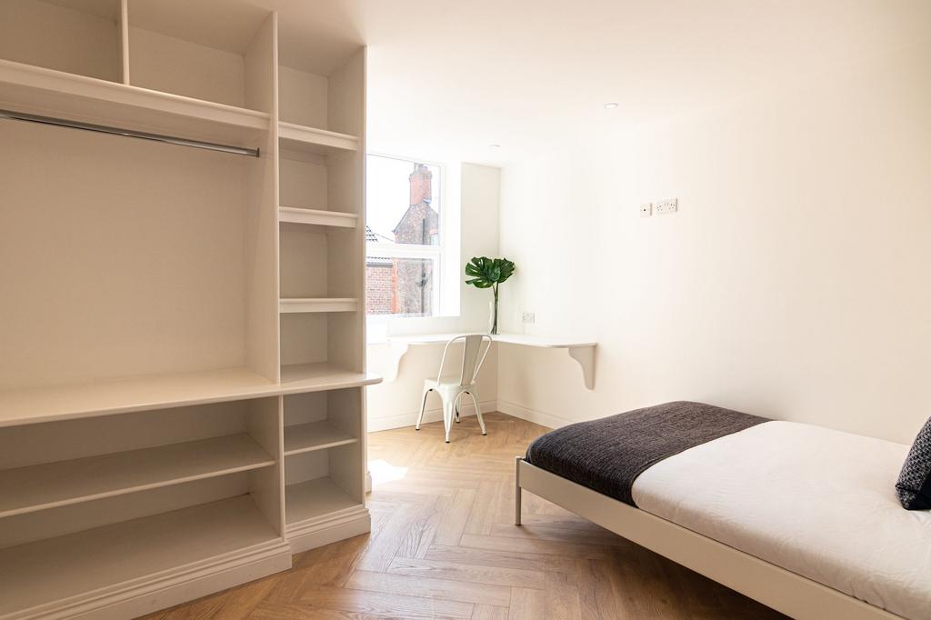 Bright and airy bedroom featuring a comfortable...
