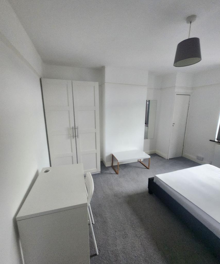 Bright and airy bedroom featuring a comfortable...