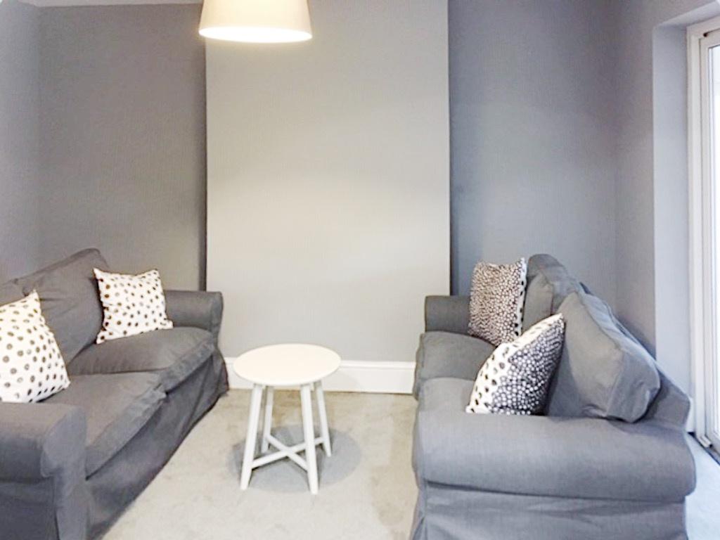 Neat contemporary living room with two matching...