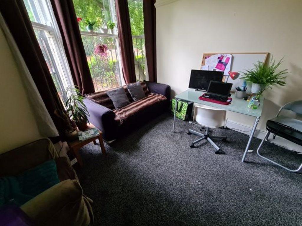A comfortable living room featuring a sofa, a d...
