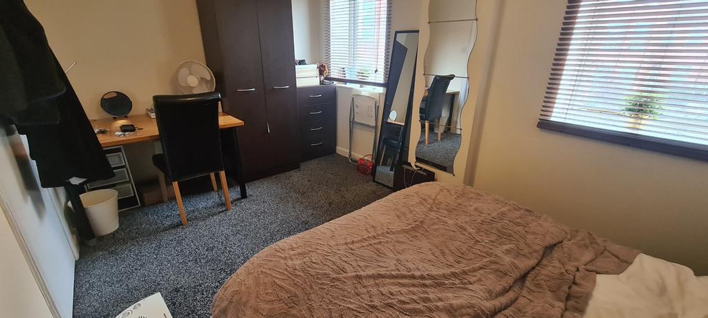 A cozy bedroom featuring a comfortable bed with...