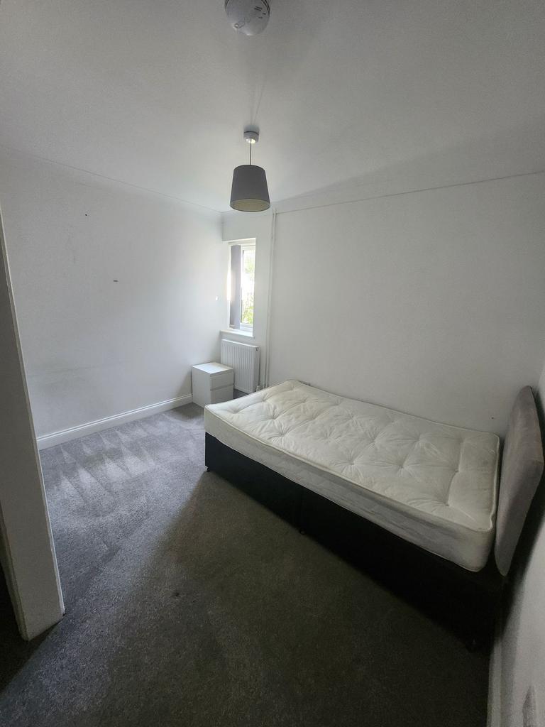A bright and minimalist living room featuring a...