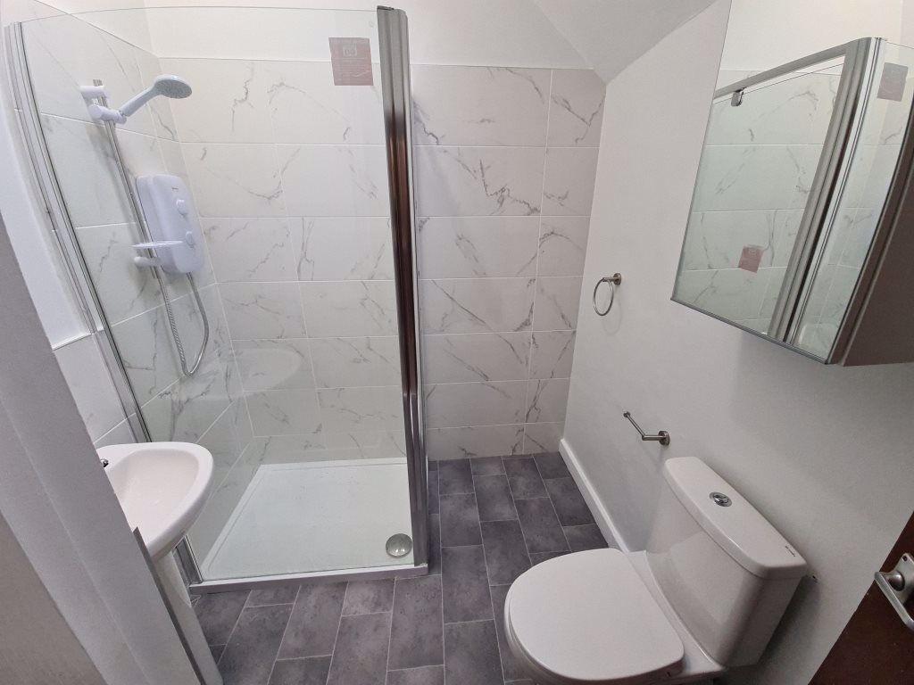 A modern bathroom featuring a walk-in shower wi...