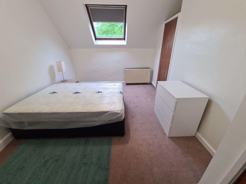 A neat single bedroom featuring a comfortable b...