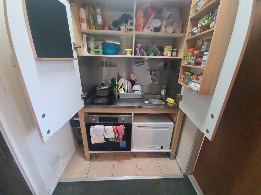 Compact and well-organized kitchen with ample s...