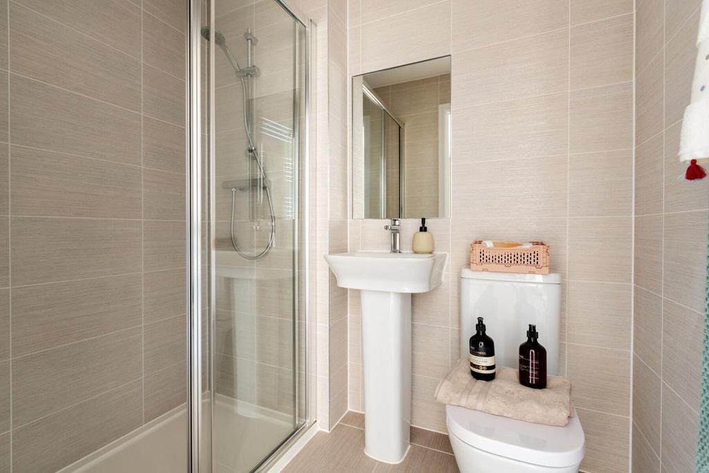 An en-suite with full width shower cubicle