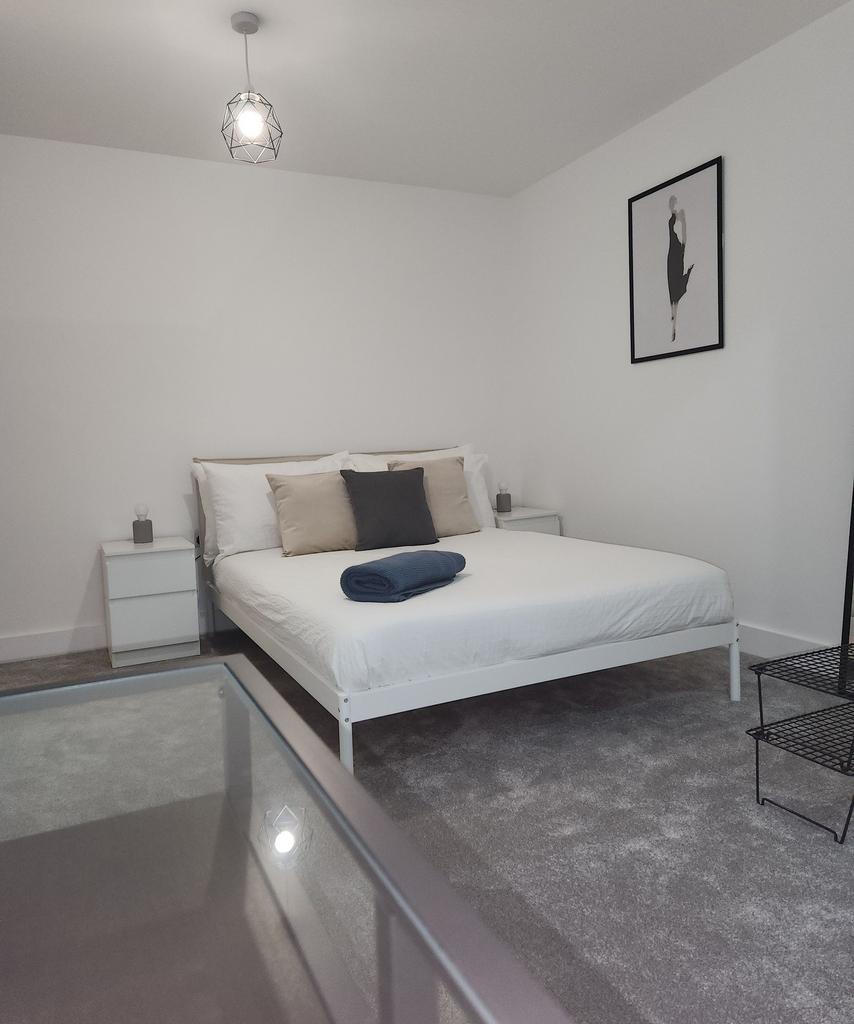 A modern, minimalist master bedroom featuring a...