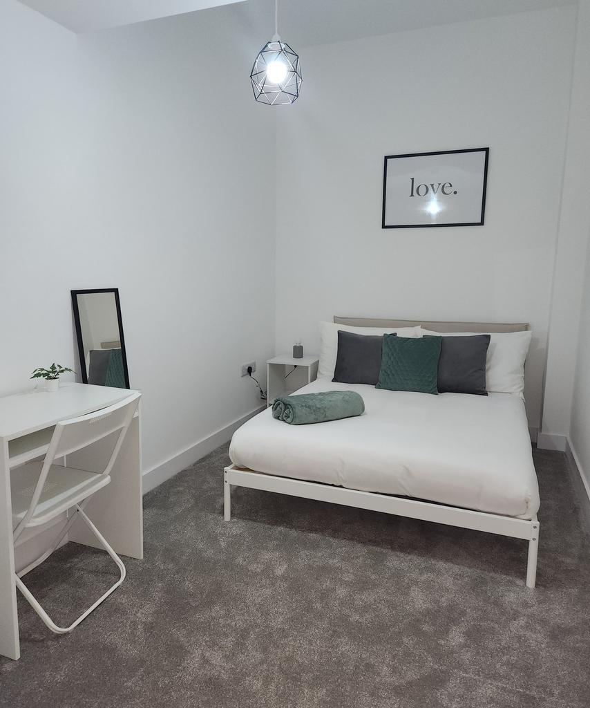 A modern, neatly maintained double bedroom with...